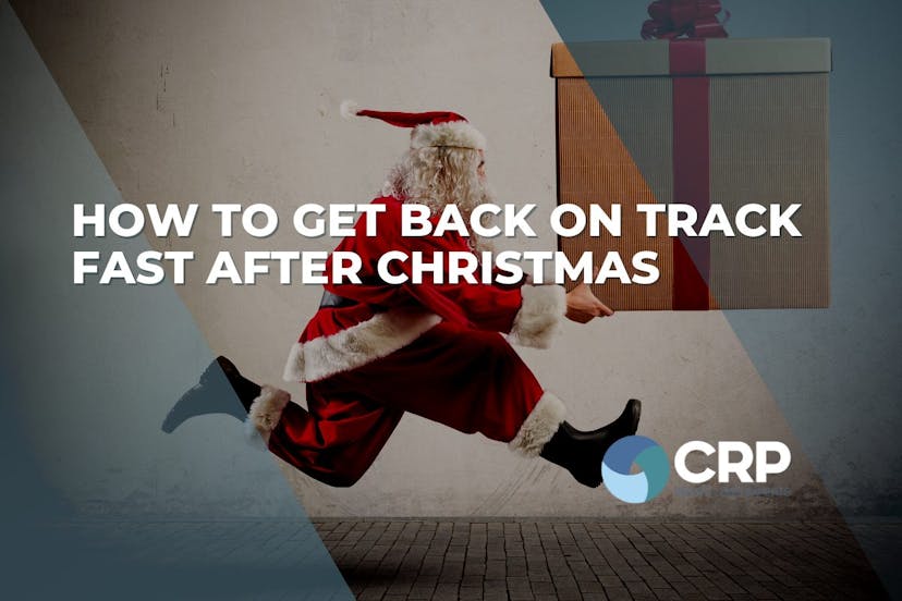 Photo of Santa jumping with a large gift in his hands. The caption reads "how to get back on track fast after Christmas"